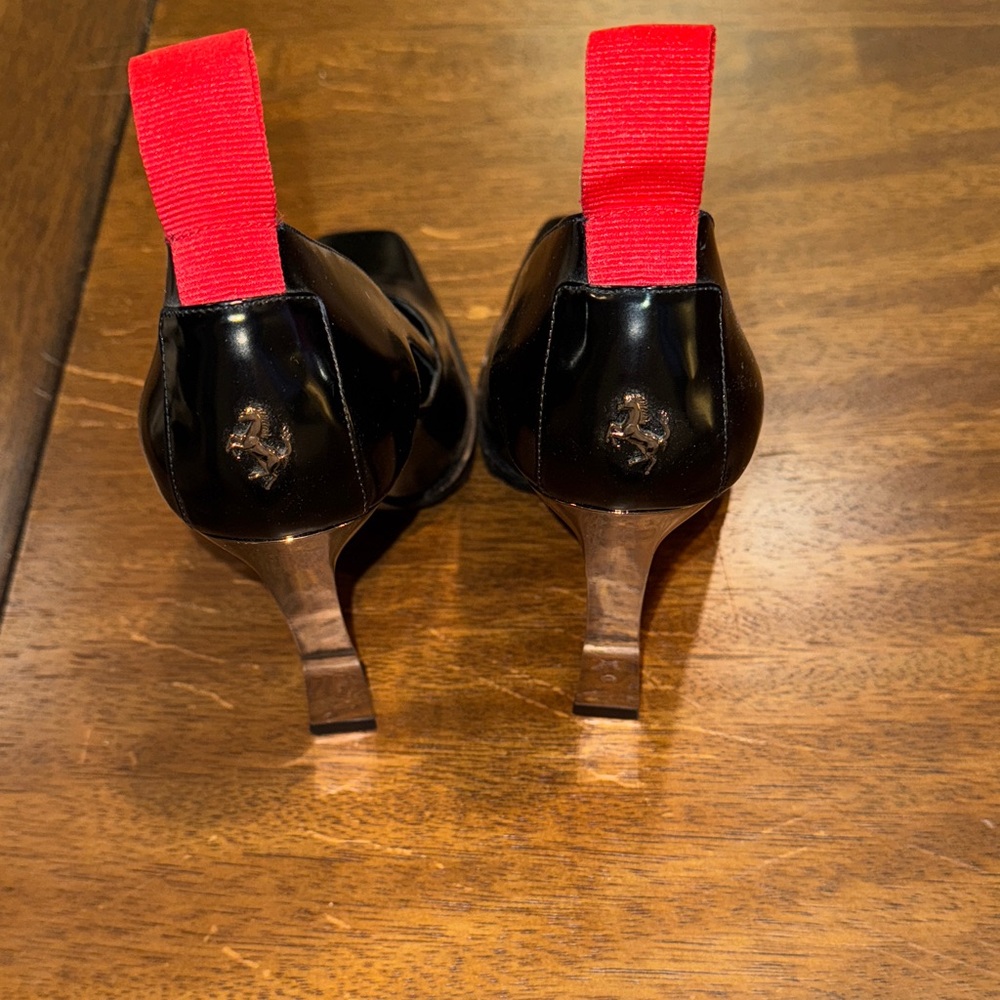 Ferrari Style black with chrome heels and red tab. Currently on Yoox for $600